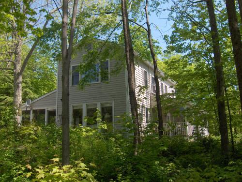149 Tyringham Road Monterey, MA 01245 - Photo 1 of 6 a view of house with outdoor space and garden
