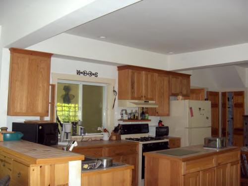 149 Tyringham Road Monterey, MA 01245 - Photo 3 of 6 a kitchen with refrigerator and cabinets