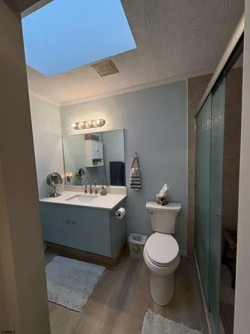a bathroom with a sink a toilet and a mirror