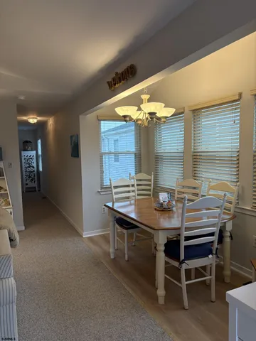 a view of a dining room with furniture and window