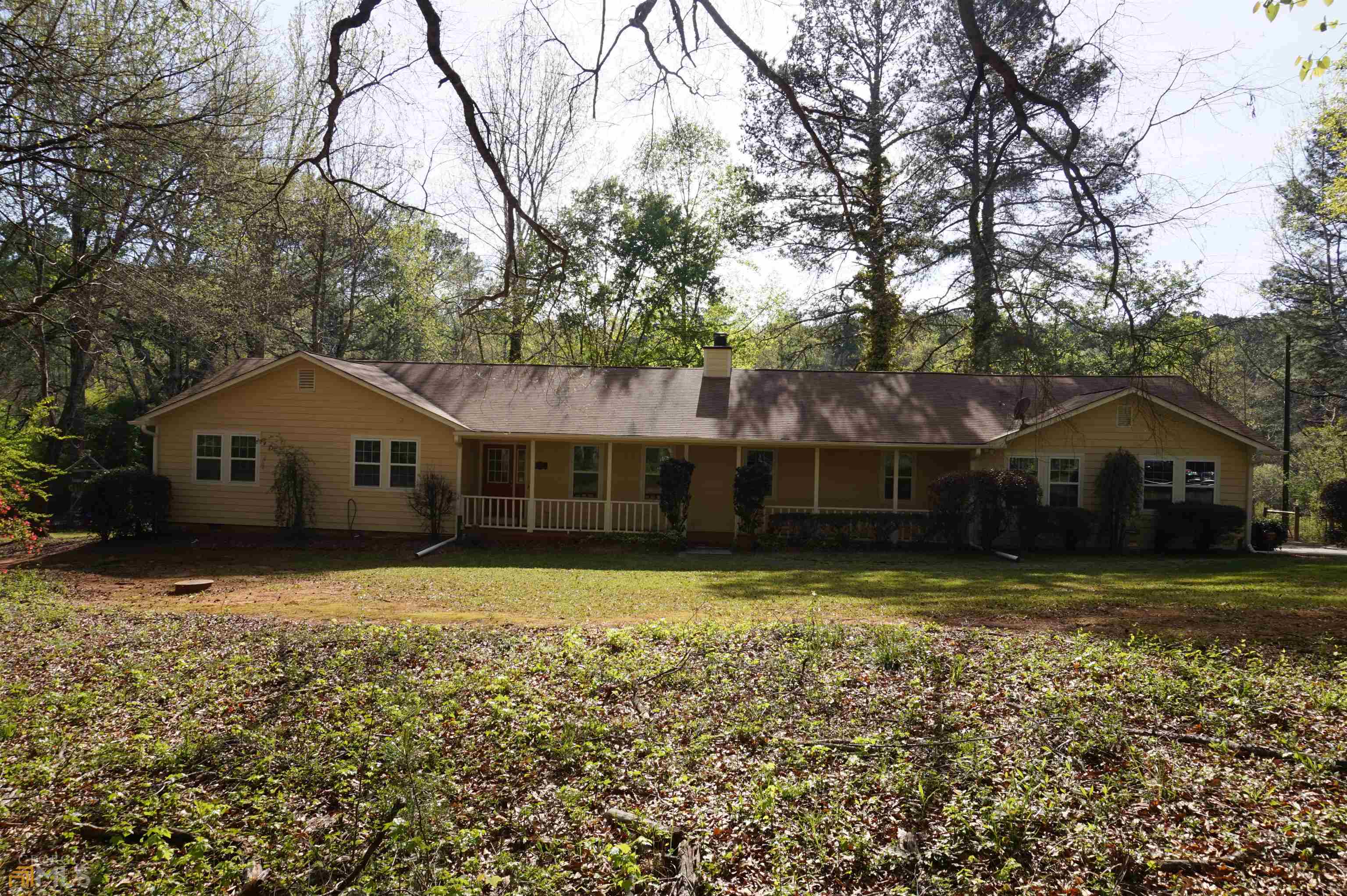 108 Floyd Road Hampton, GA 30228 - Photo 1 of 1 a front view of a house with a yard and large tree