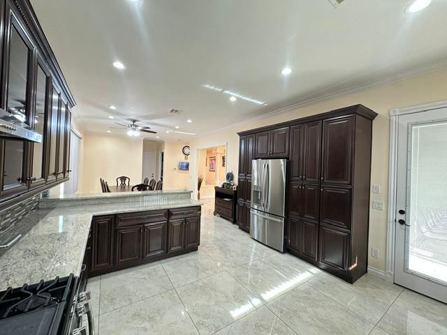 6830 North 14th Street Phoenix, AZ 85014 - Photo 7 of 28 a large kitchen with a large counter top stainless steel appliances and cabinets