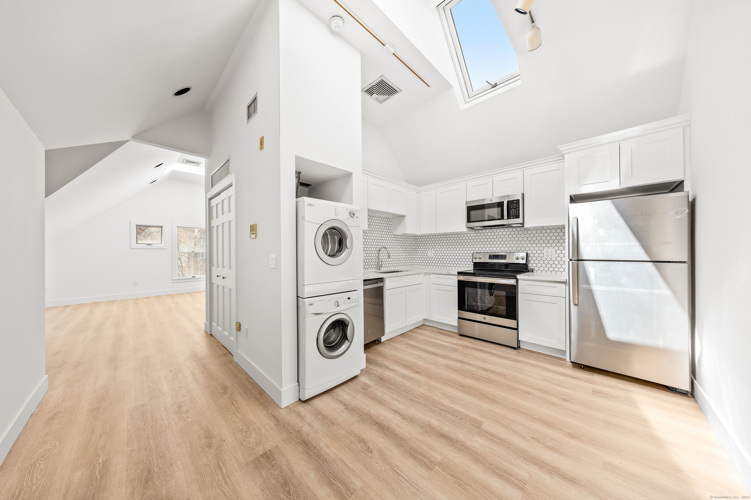 a kitchen with stainless steel appliances a stove a refrigerator and cabinets