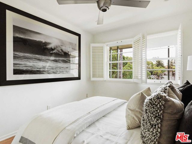 a bedroom with a bed and a night stand