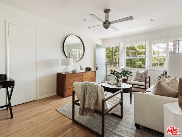 a living room with furniture a window and a chandelier