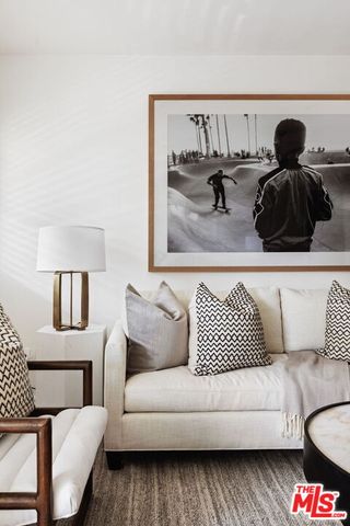 a living room with furniture and a lamp