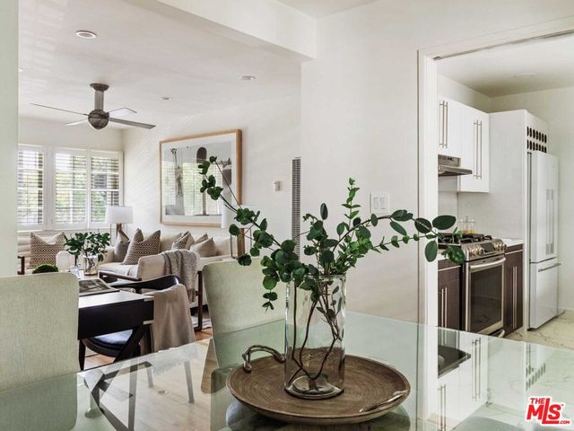 a living room with furniture potted plant and a chandelier