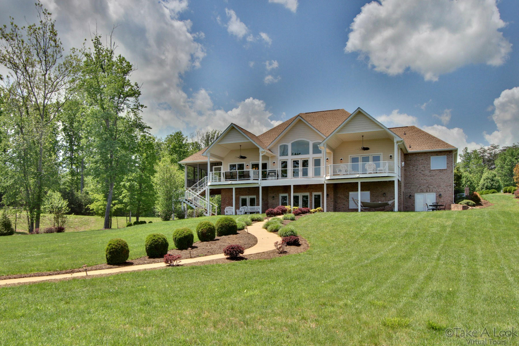 a front view of a house with a garden