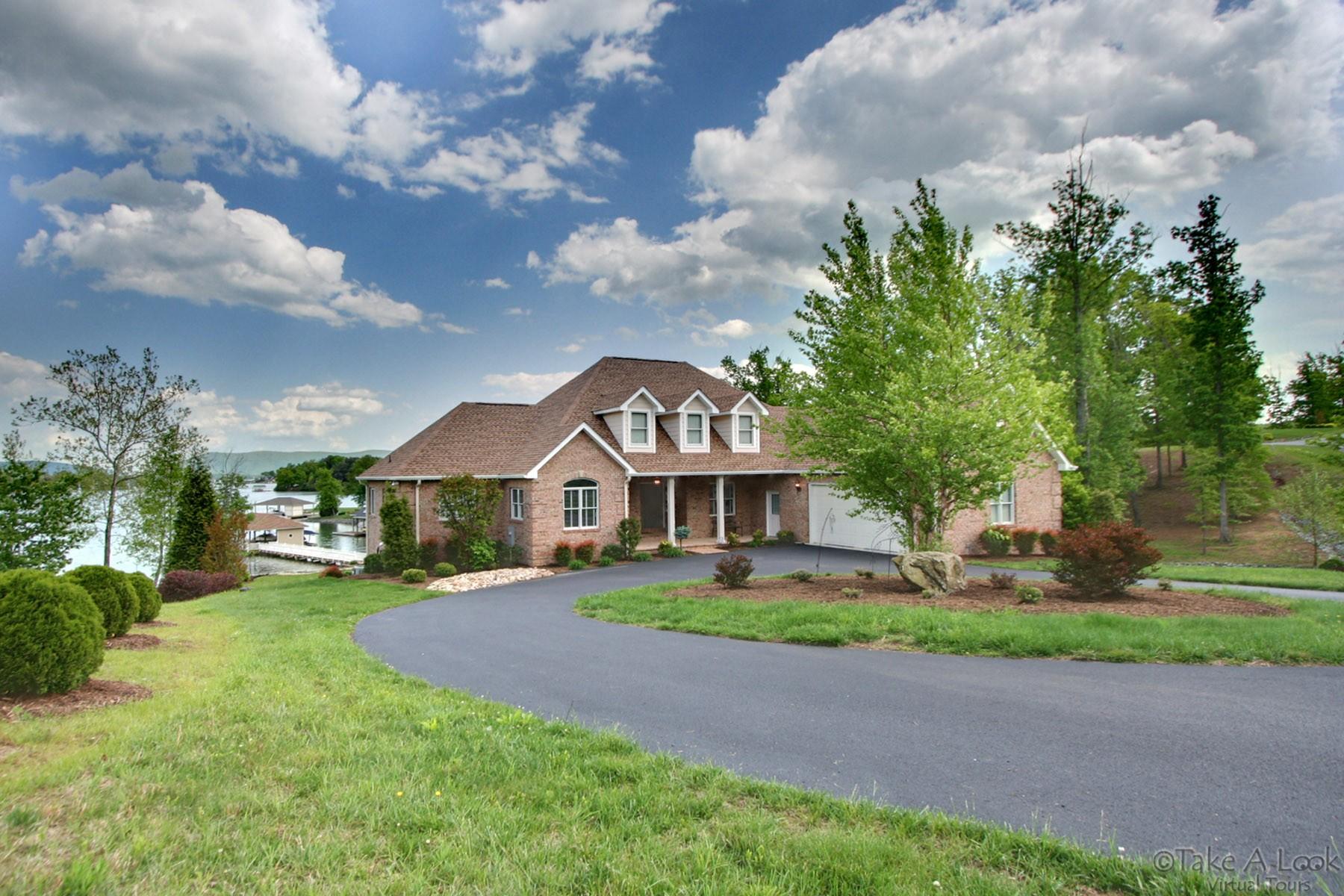 140 Calypso Road Moneta, VA 24121 - Photo 2 of 26 a front view of a house with a garden and trees