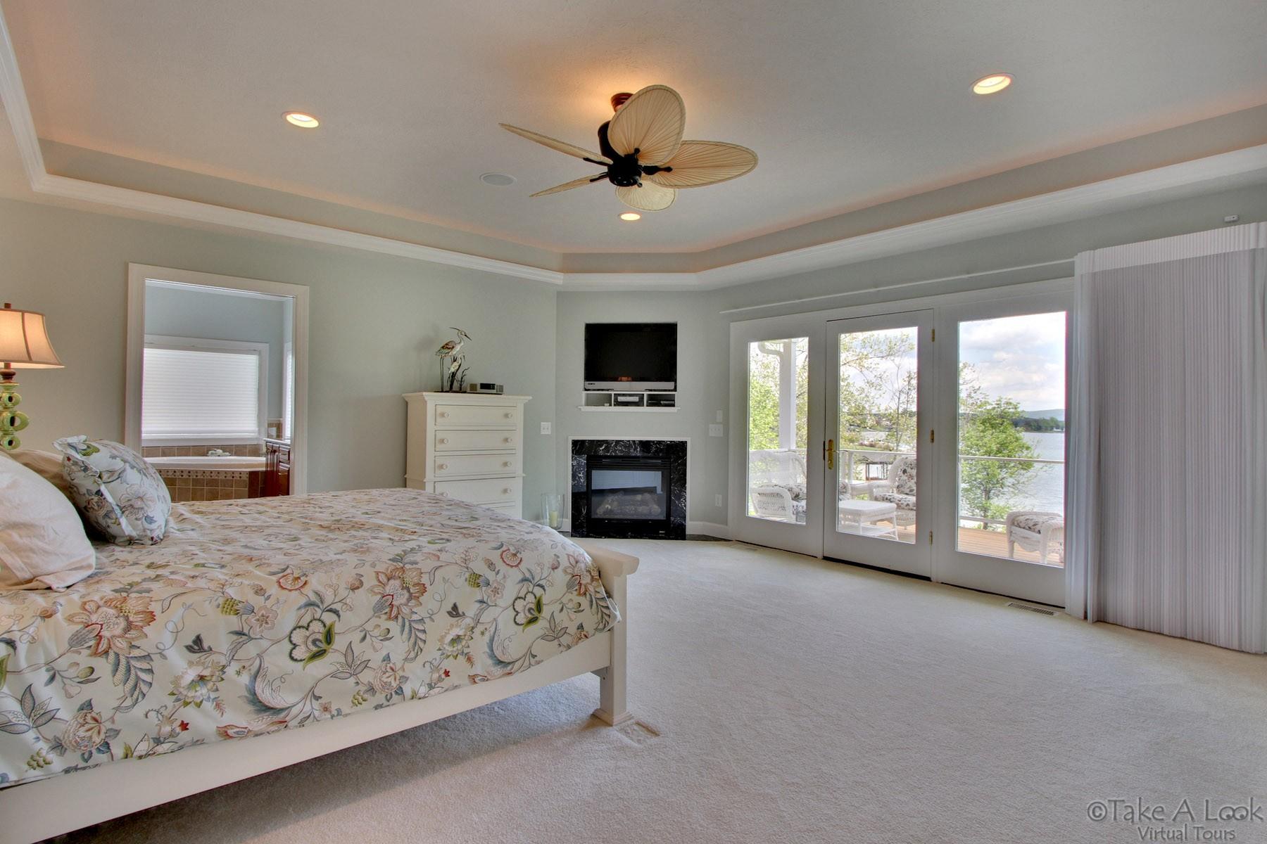 140 Calypso Road Moneta, VA 24121 - Photo 15 of 26 a spacious bedroom with a large bed and a tv