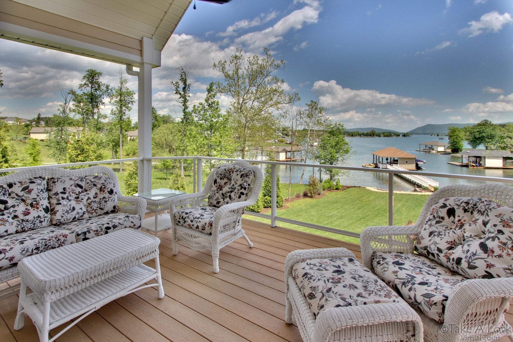 140 Calypso Road Moneta, VA 24121 - Photo 17 of 26 a view of a patio with couches chairs and a floor to ceiling window with outer view
