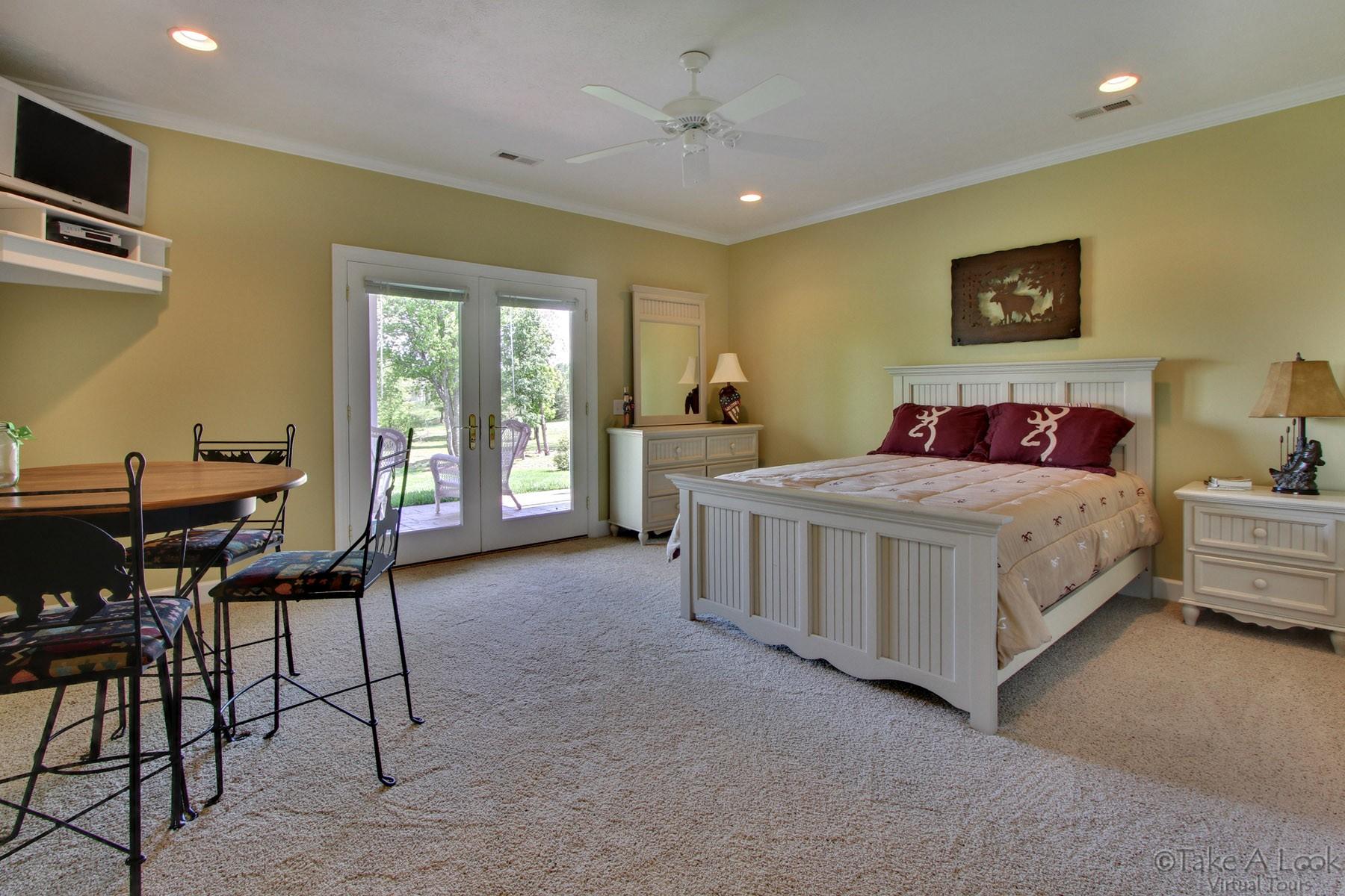 140 Calypso Road Moneta, VA 24121 - Photo 21 of 26 a bedroom with a bed and a table