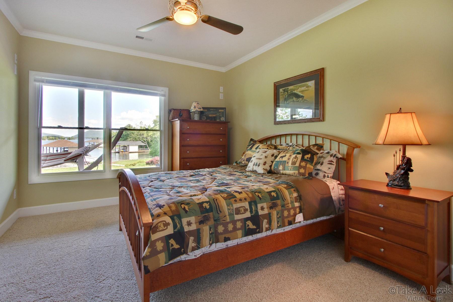 140 Calypso Road Moneta, VA 24121 - Photo 22 of 26 a bedroom with a bed window and a lamp