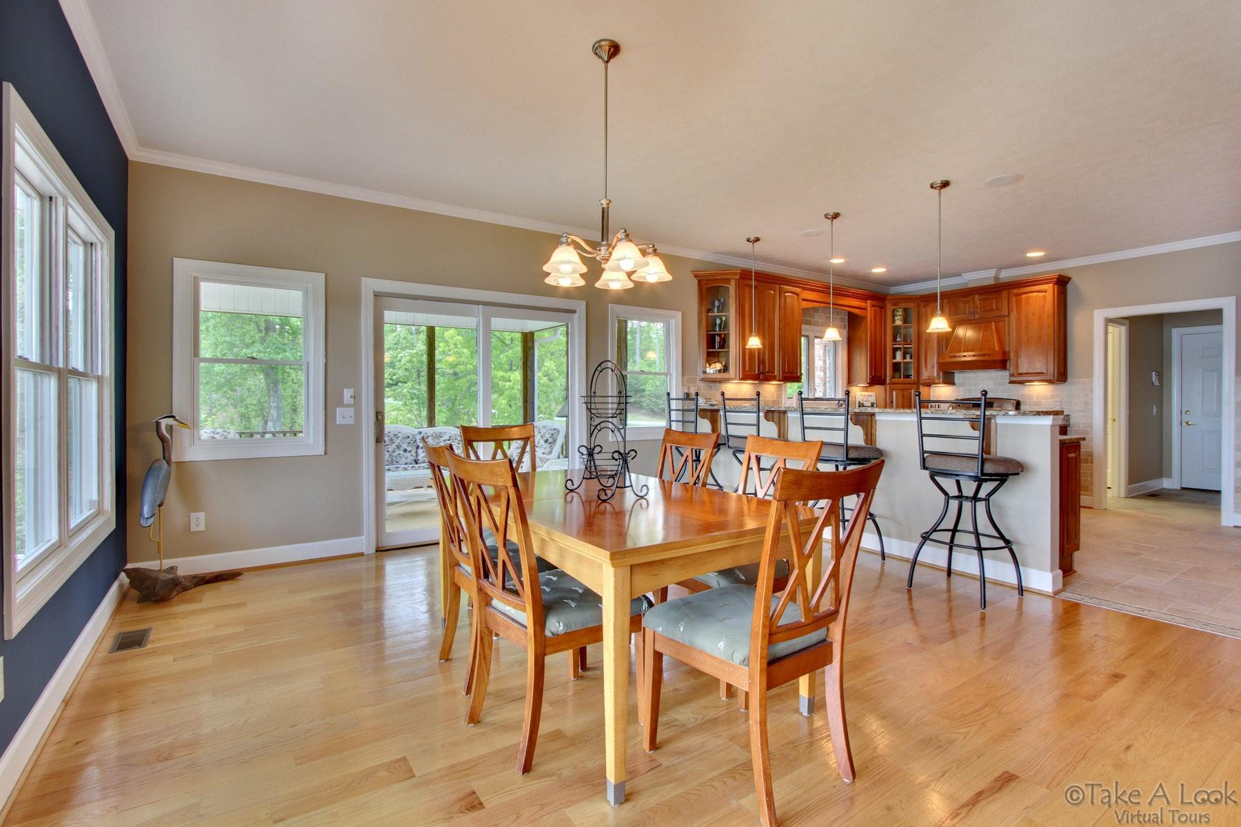 140 Calypso Road Moneta, VA 24121 - Photo 8 of 26 a view of a dining room with furniture window and wooden floor