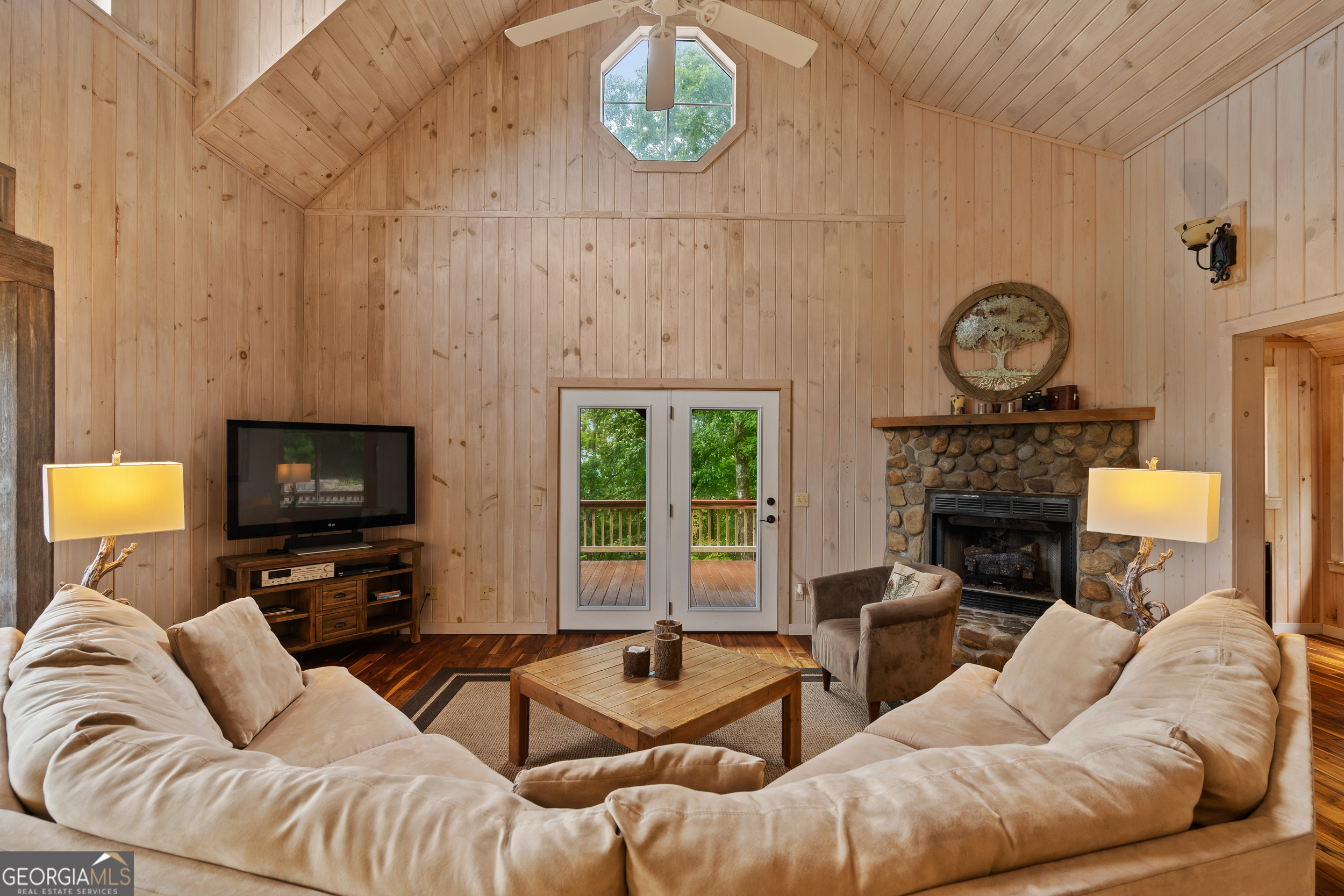1387 Valley Street Clayton, GA 30525 - Photo 12 of 59 a living room with furniture a fireplace and a flat tv screen