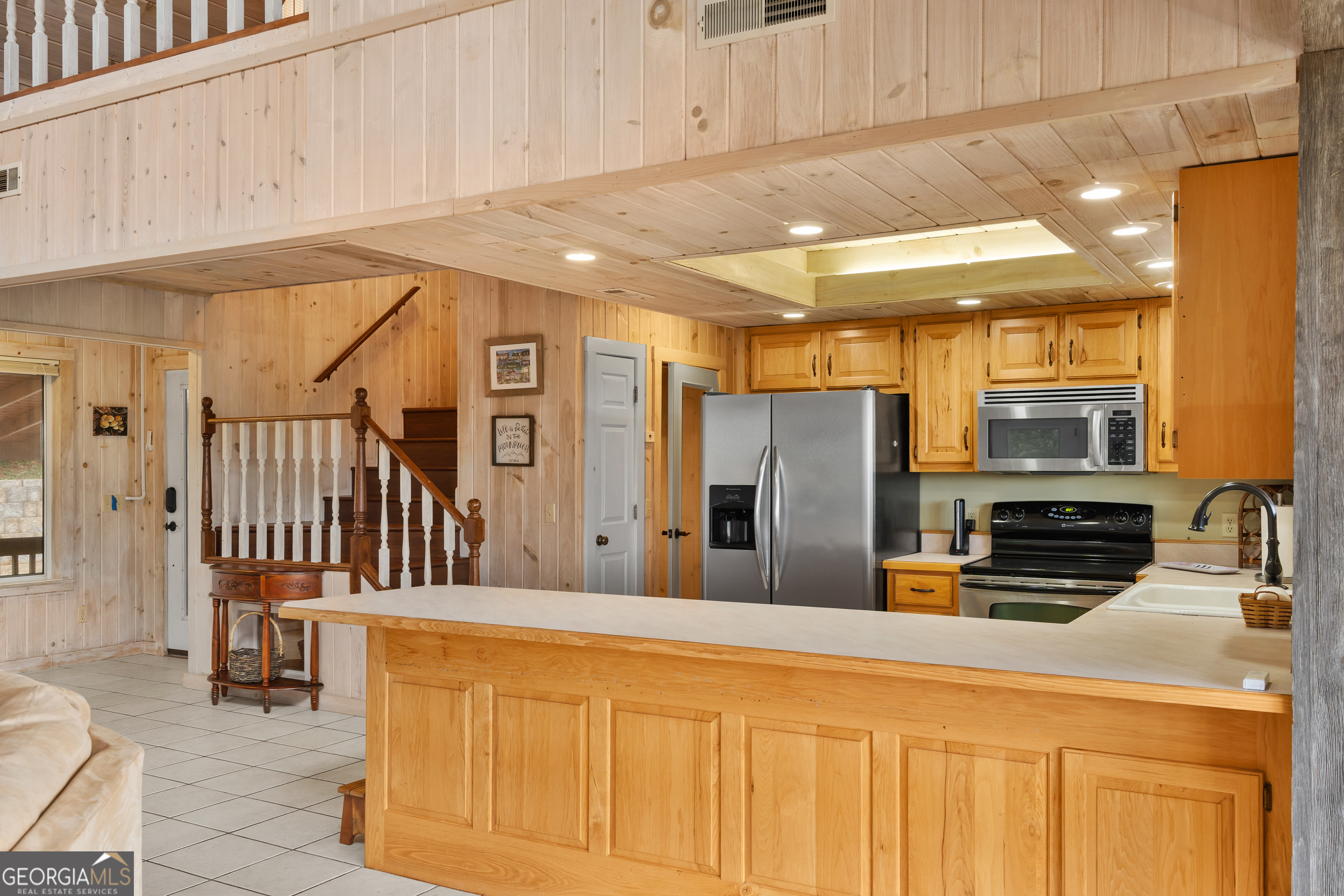 1387 Valley Street Clayton, GA 30525 - Photo 17 of 59 a kitchen with stainless steel appliances a refrigerator and cabinets