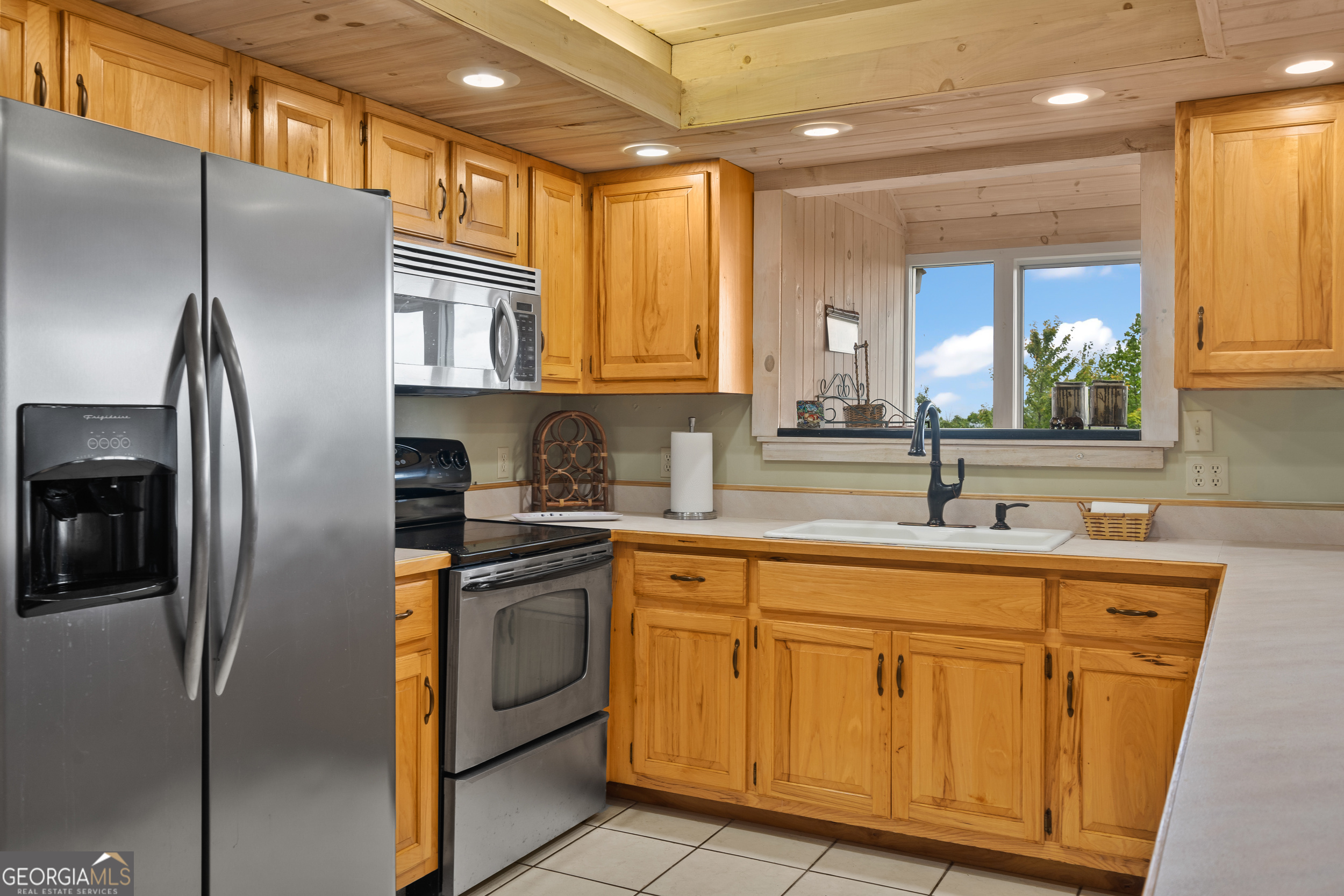 1387 Valley Street Clayton, GA 30525 - Photo 19 of 59 a kitchen with stainless steel appliances granite countertop a sink a refrigerator and a window