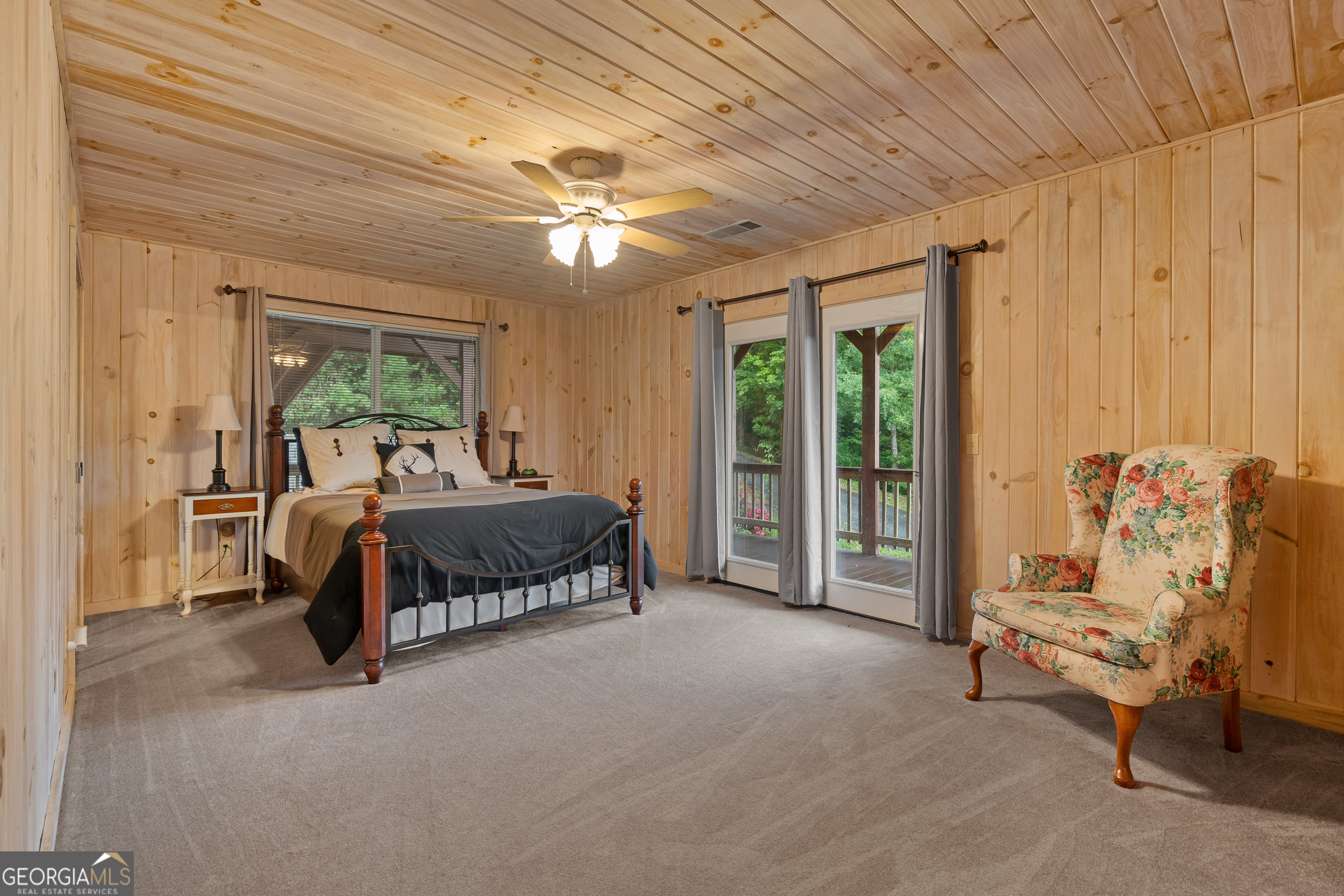 1387 Valley Street Clayton, GA 30525 - Photo 27 of 59 a spacious bedroom with a bed and a chandelier