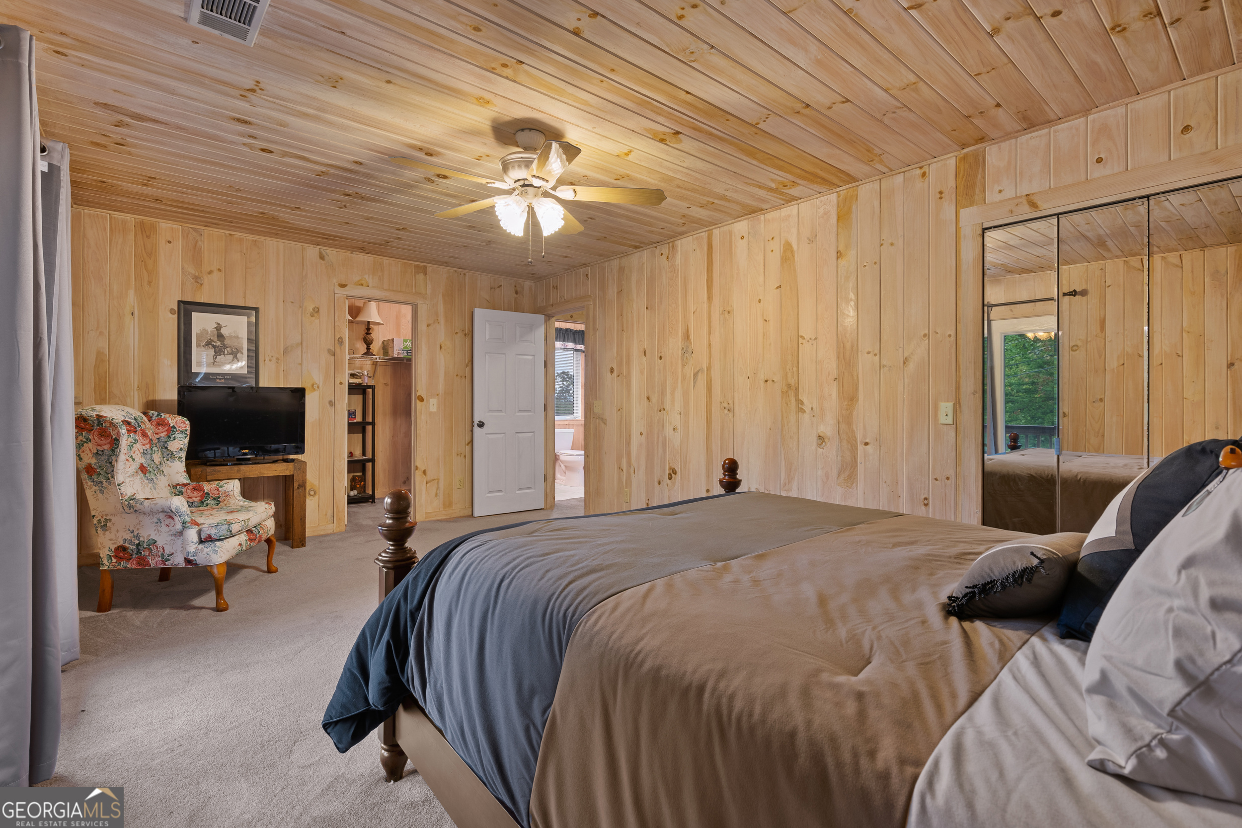1387 Valley Street Clayton, GA 30525 - Photo 28 of 59 a spacious bedroom with a bed couch and a window