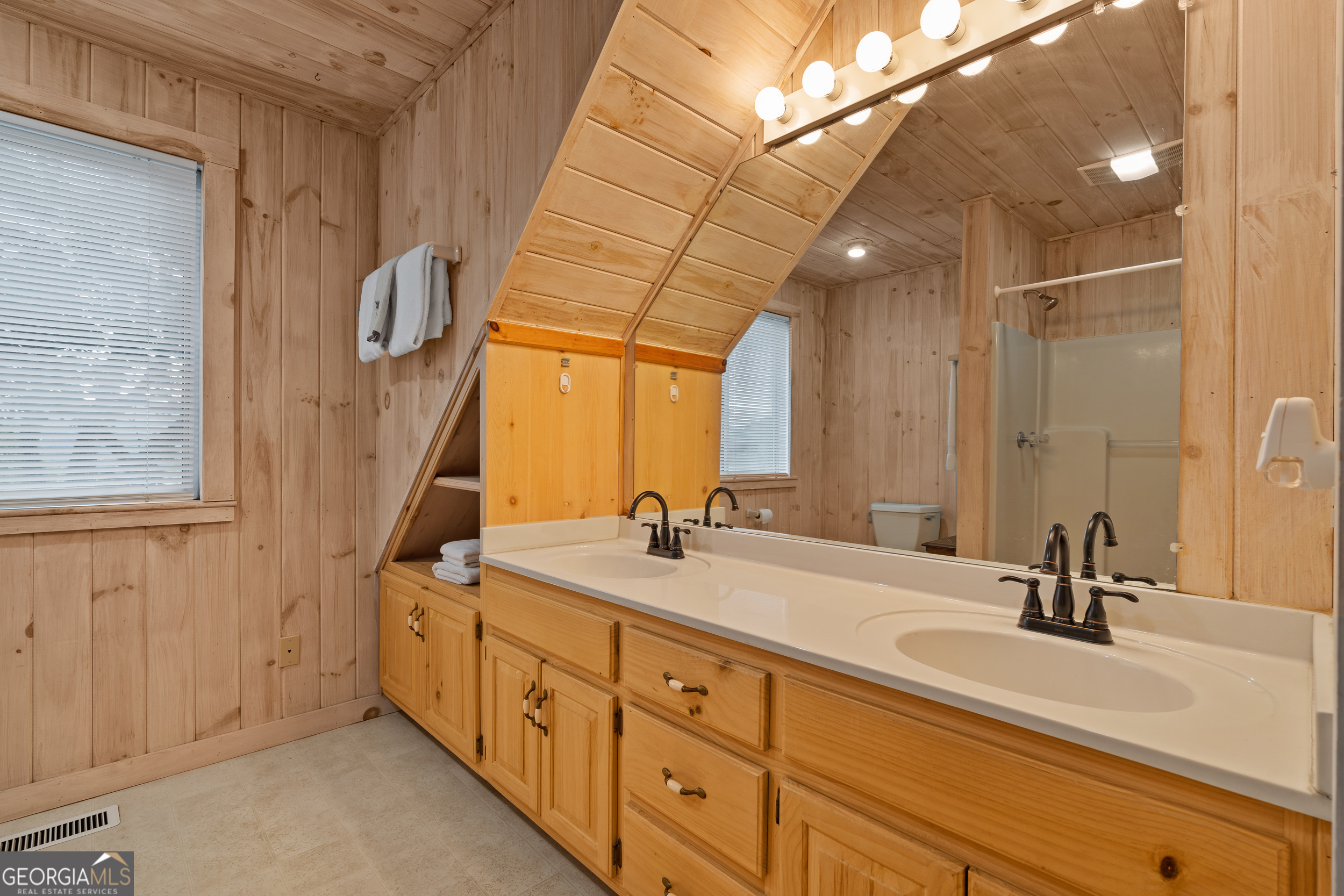 1387 Valley Street Clayton, GA 30525 - Photo 31 of 59 a spacious bathroom with a double vanity sink and mirror