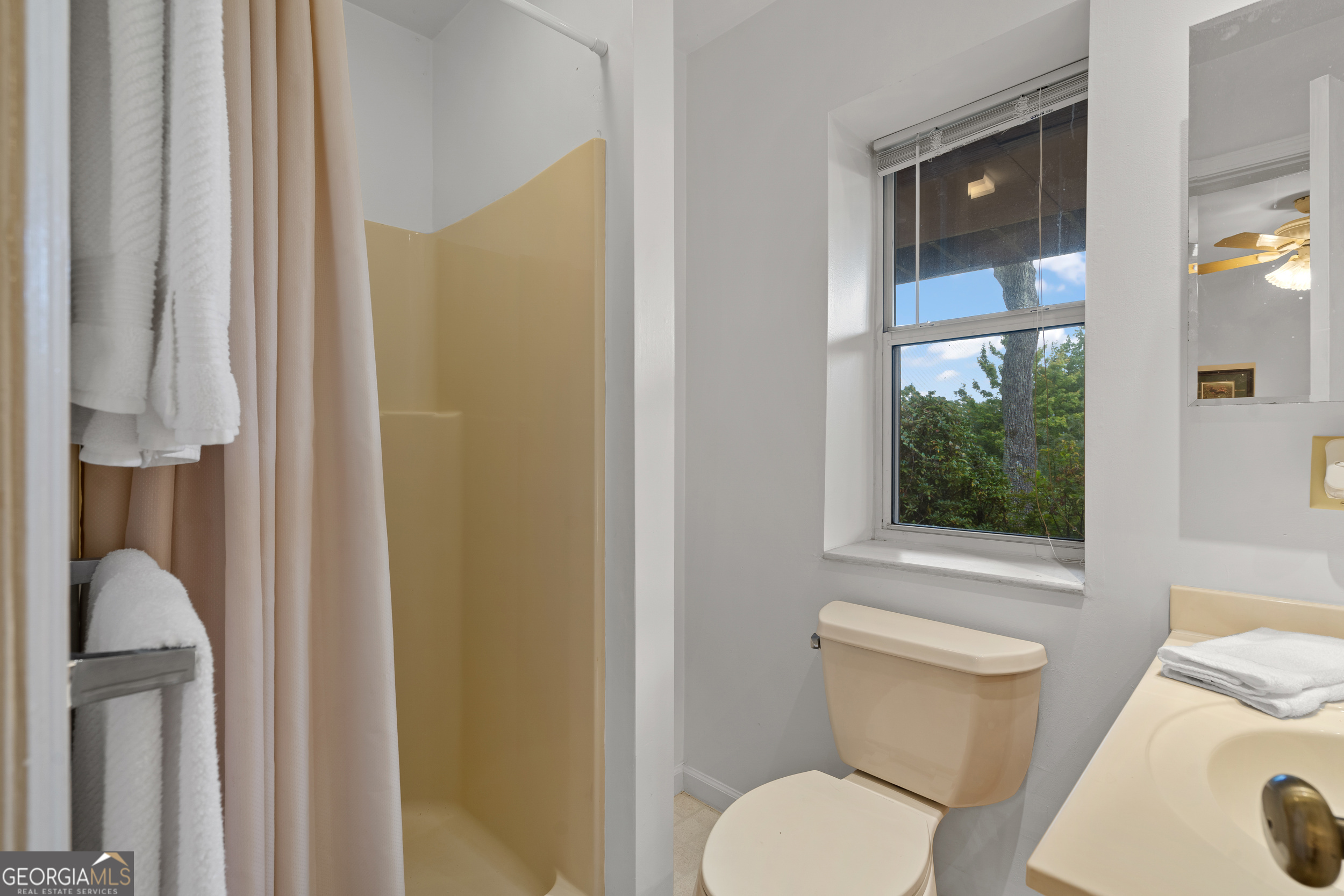 1387 Valley Street Clayton, GA 30525 - Photo 41 of 59 a white toilet sitting next to a bathroom sink