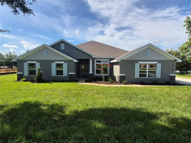 a front view of house with yard and green space