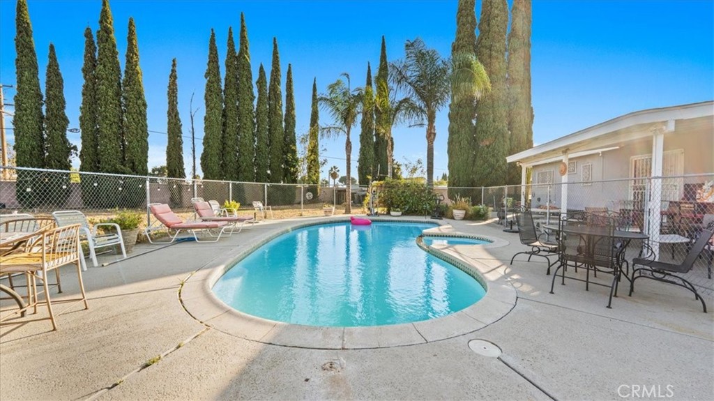 215 West Valencia Street Rialto, CA 92376 - Photo 12 of 17 a view of a swimming pool with outdoor seating