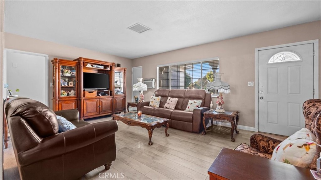 215 West Valencia Street Rialto, CA 92376 - Photo 5 of 17 a living room with furniture and a flat screen tv