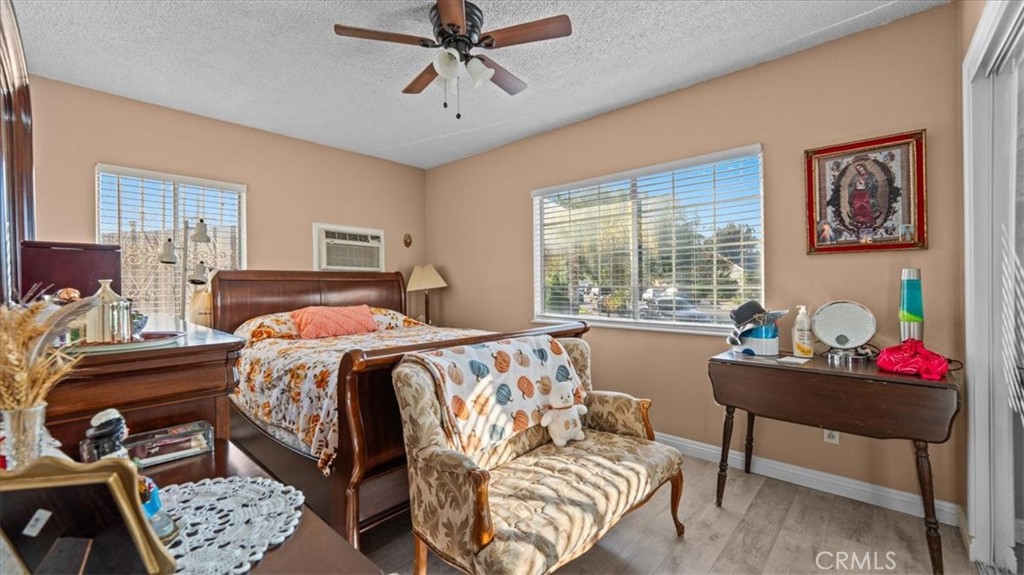 215 West Valencia Street Rialto, CA 92376 - Photo 7 of 17 a bedroom with a bed and windows