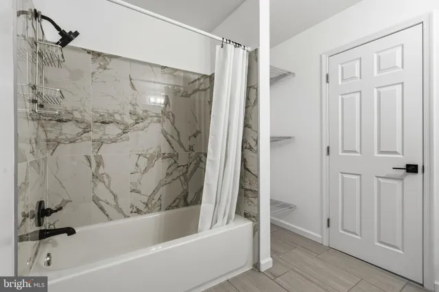 a bathroom with a bathtub and a shower
