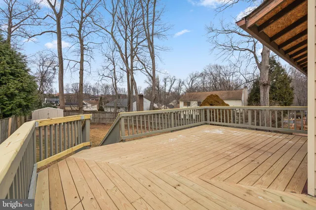 a view of balcony with wooden floor and fence