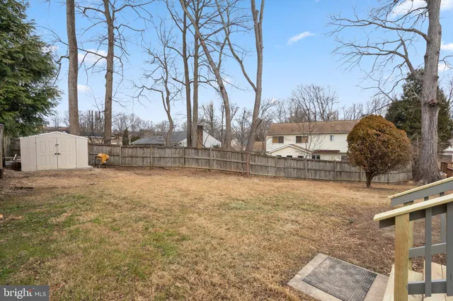 a backyard of apartments with large trees