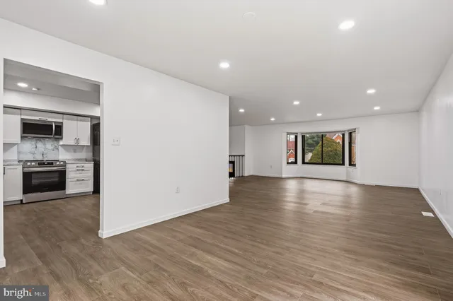 a view of a kitchen with a sink and a stove top oven