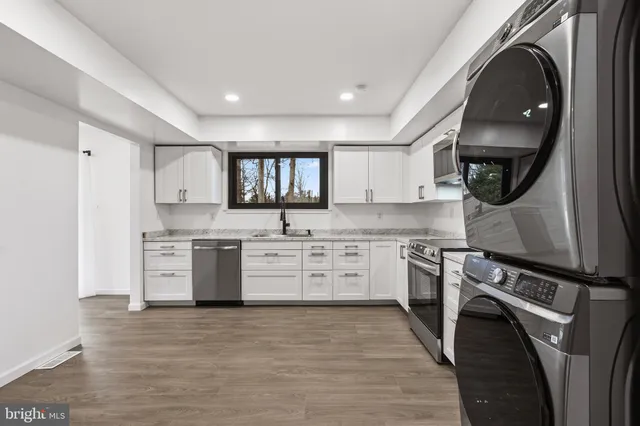 a kitchen with a stove top oven sink and cabinets