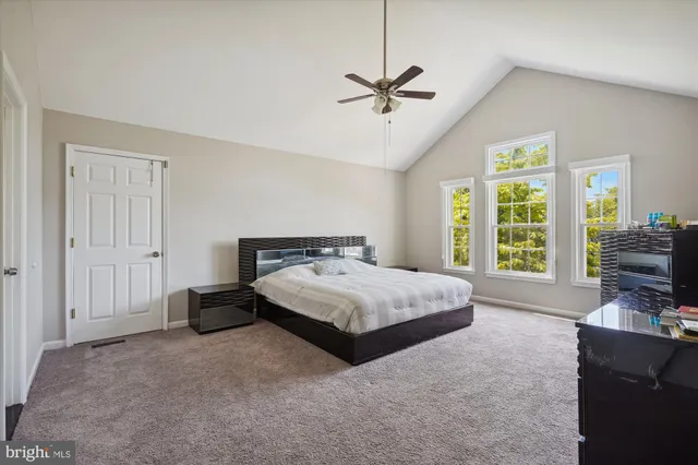 a spacious bedroom with a bed and a couch