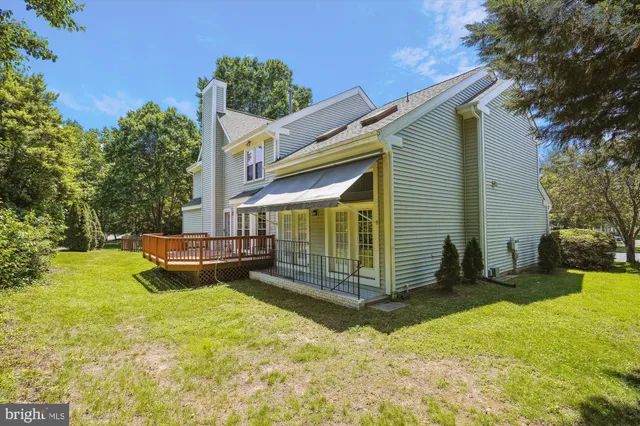a view of a house with a yard and sitting area