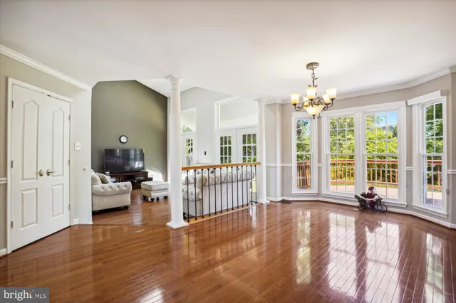 a view of a livingroom with furniture wooden floor and windows