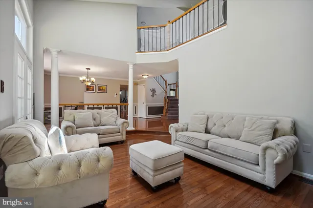 a living room with furniture and a chandelier