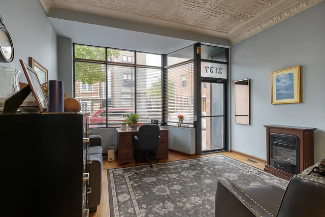 a view of work space with furniture and windows