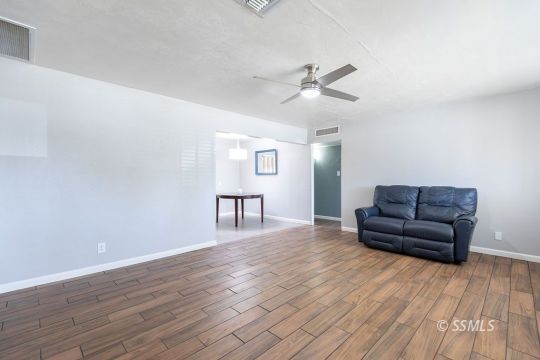 240 West Graaf Avenue Ridgecrest, CA 93555 - Photo 8 of 28 a living room with furniture and a wooden floor