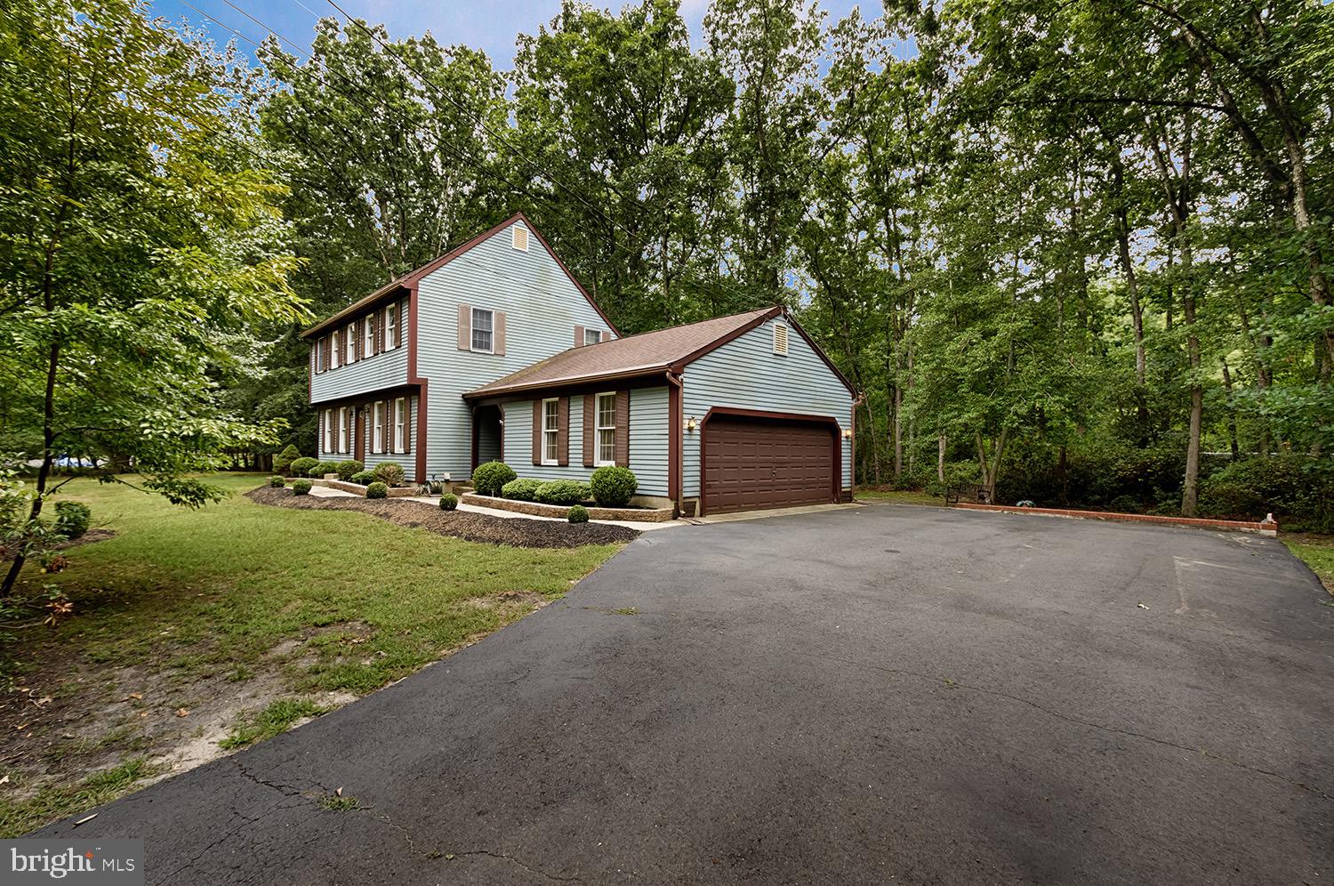 19 New Road Tabernacle, NJ 08088 - Photo 2 of 25 a front view of a house with a yard and garage