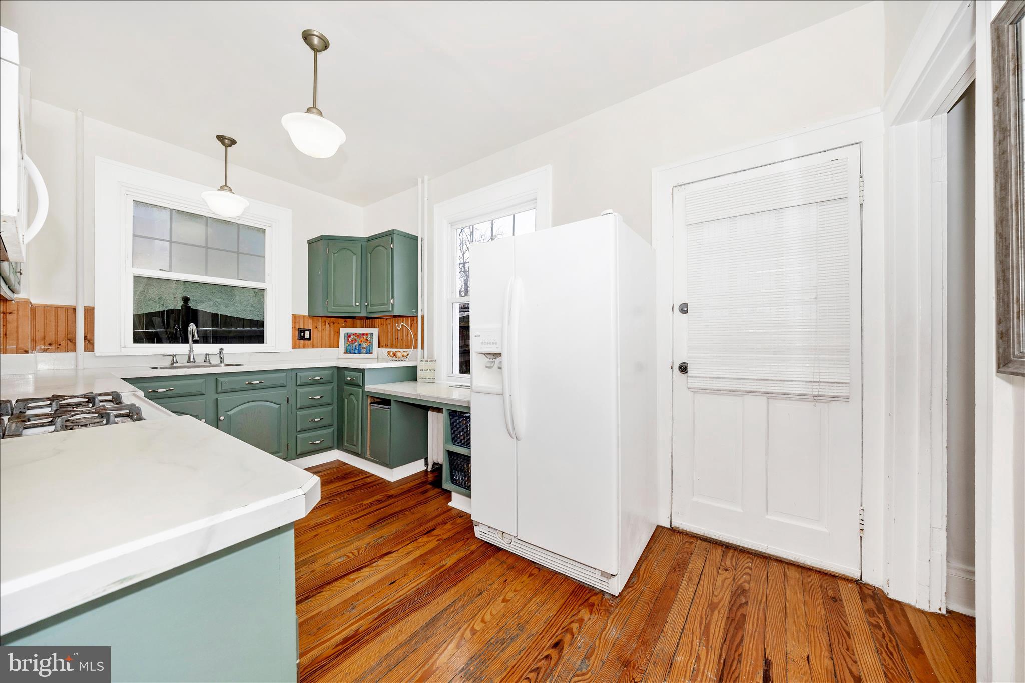 707 Summit Avenue Hagerstown, MD 21740 - Photo 13 of 54 a open kitchen with a sink dishwasher stove and white cabinets with wooden floor