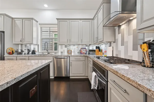 a kitchen with a table chairs sink and cabinets