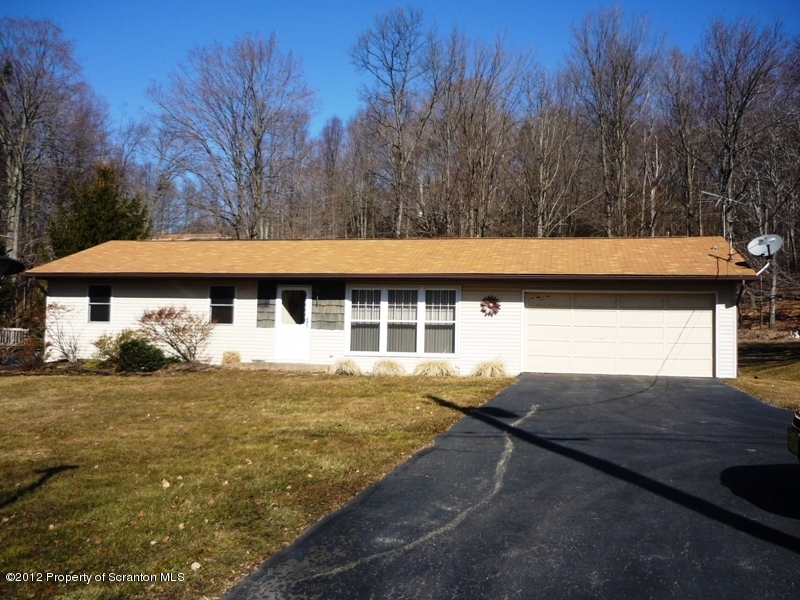 891 St Rt 502 Spring Brook Moscow, PA 18444 - Photo 1 of 41 a view of house with yard and trees in the background