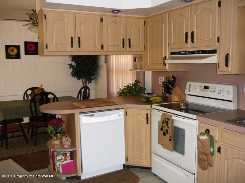 891 St Rt 502 Spring Brook Moscow, PA 18444 - Photo 13 of 41 a kitchen with stainless steel appliances granite countertop a sink and cabinets