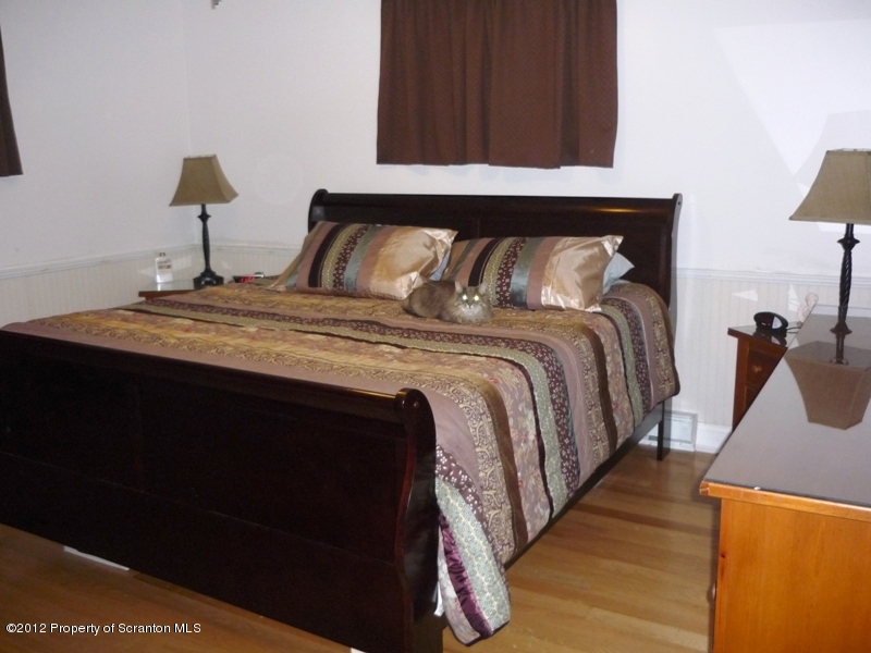 891 St Rt 502 Spring Brook Moscow, PA 18444 - Photo 15 of 41 a bedroom with bed and wooden floor