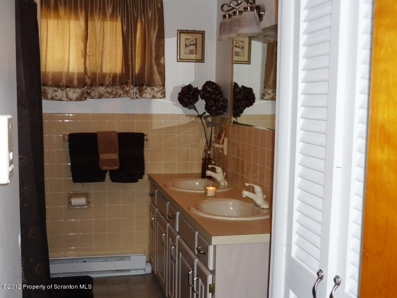 891 St Rt 502 Spring Brook Moscow, PA 18444 - Photo 18 of 41 a bathroom with a sink and a mirror