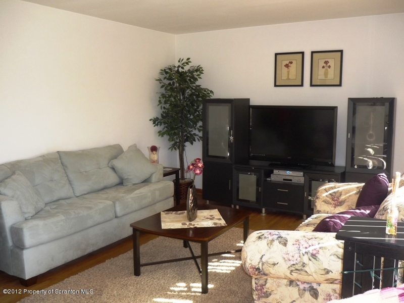 891 St Rt 502 Spring Brook Moscow, PA 18444 - Photo 2 of 41 a living room with furniture and a flat screen tv