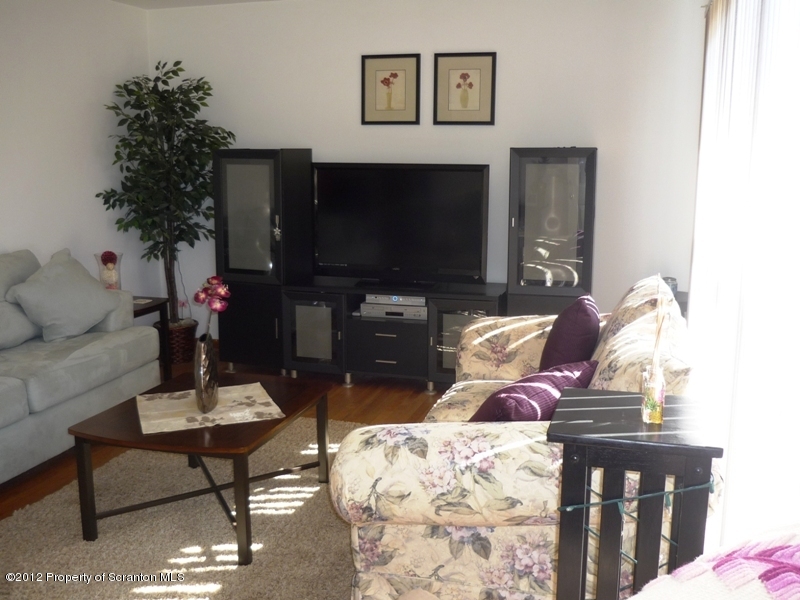 891 St Rt 502 Spring Brook Moscow, PA 18444 - Photo 7 of 41 a living room with furniture a flat screen tv and a fireplace