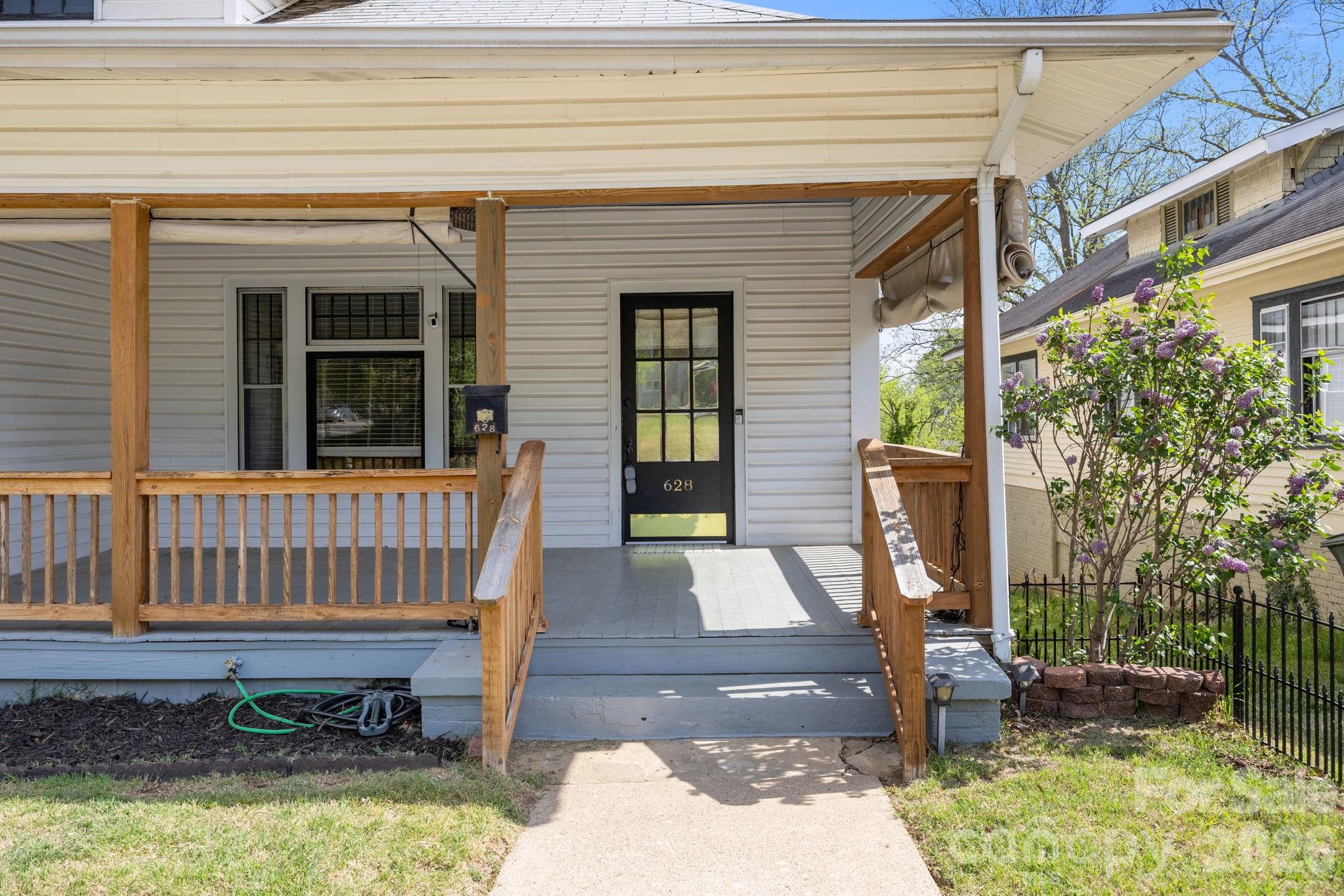 628 West Council Street Salisbury, NC 28144 - Photo 14 of 43 a view of a porch with a chairs and potted plant
